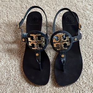 Tory Burch navy blue leather sandal with gold logo and wooden stacked 3” heel.